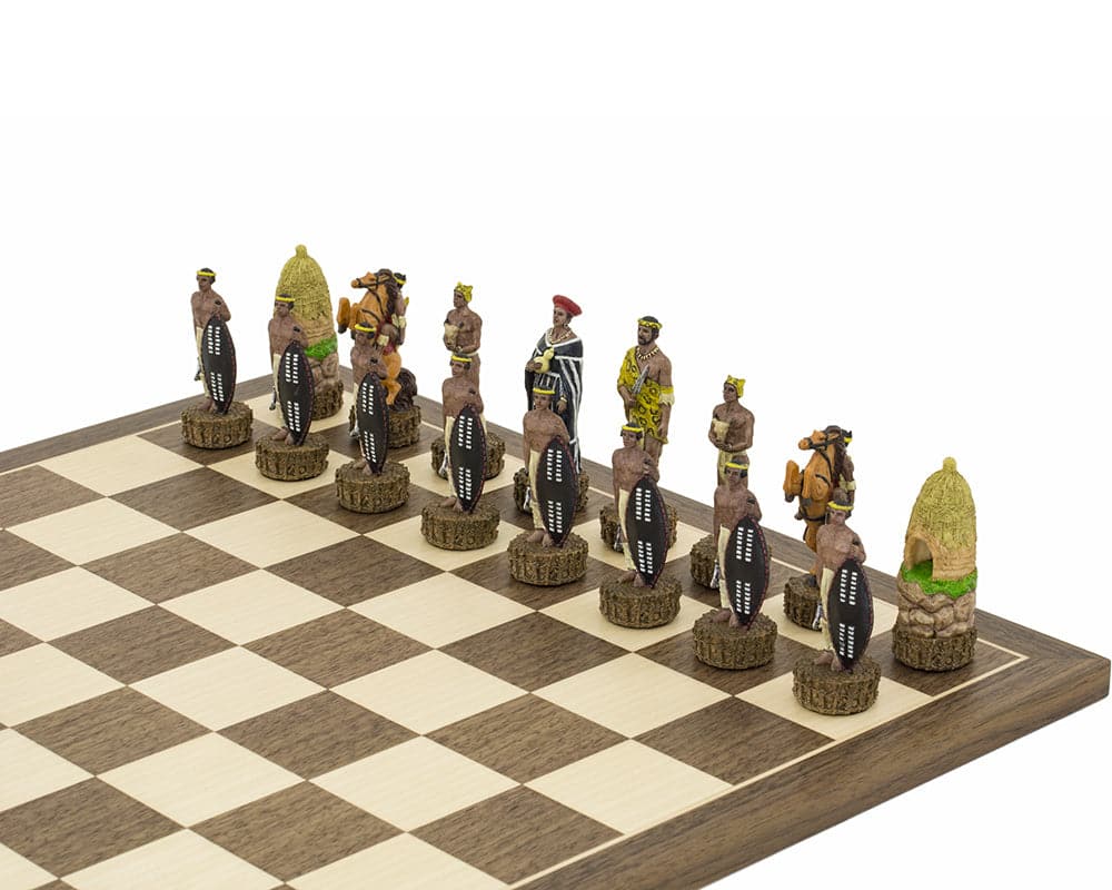 Ornate hand-painted Zulu chess pieces on a chessboard by Italafama, featuring 3.25-inch king, superb quality, and detailed craftsmanship.