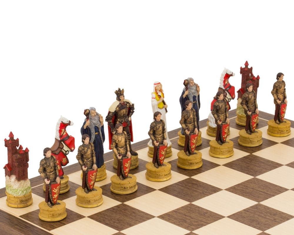 Hand-painted King Arthur themed chess pieces by Italfama on a chessboard, featuring intricately detailed characters including King Arthur and Guinevere.