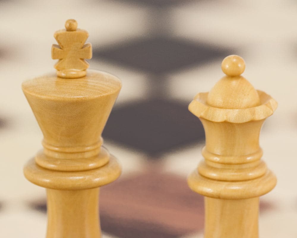 Supreme Series Ebony Staunton Chess Pieces - King and Queen Close-up on Chessboard