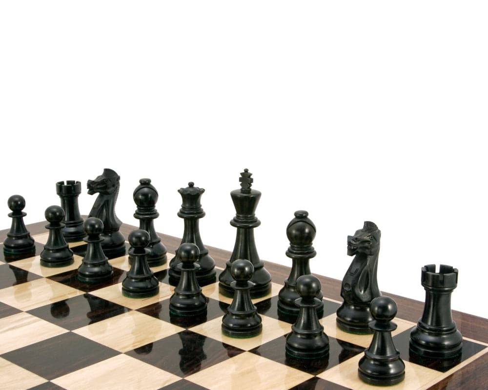 Large ebonised boxwood chess pieces from the Frankfurt Series on a chessboard, including a 4 inch king.