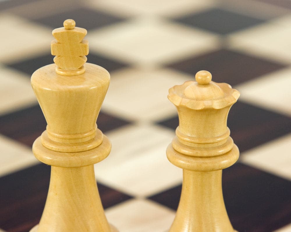 Close-up of Frankfurt Series ebonised boxwood chess king and queen pieces on a chessboard.