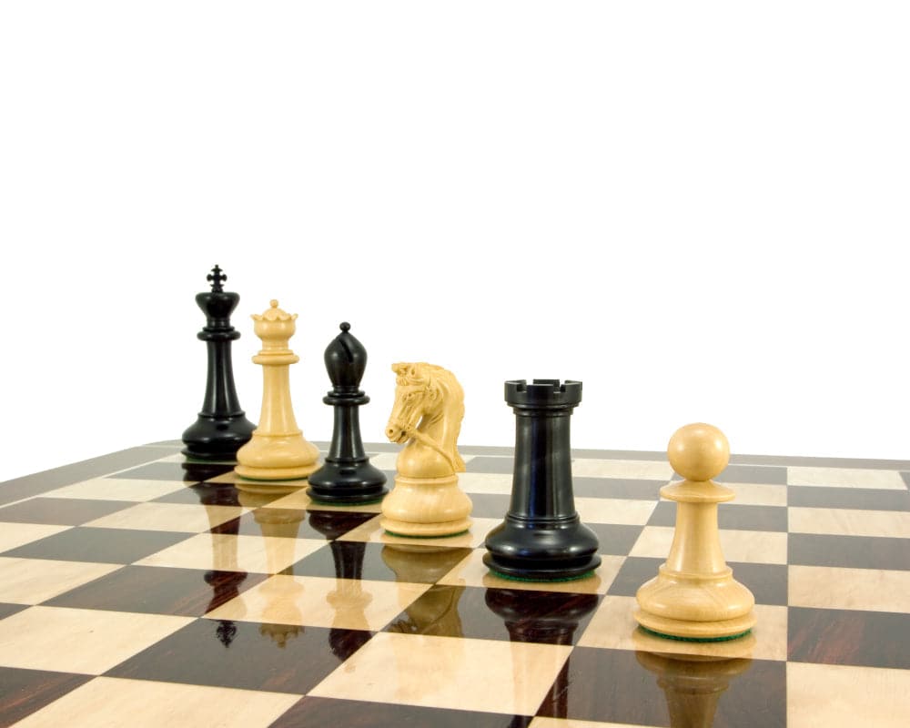 Luxury Monarch Series ebony and boxwood chess pieces on a board, highlighting supreme craftsmanship and Eastern influence.