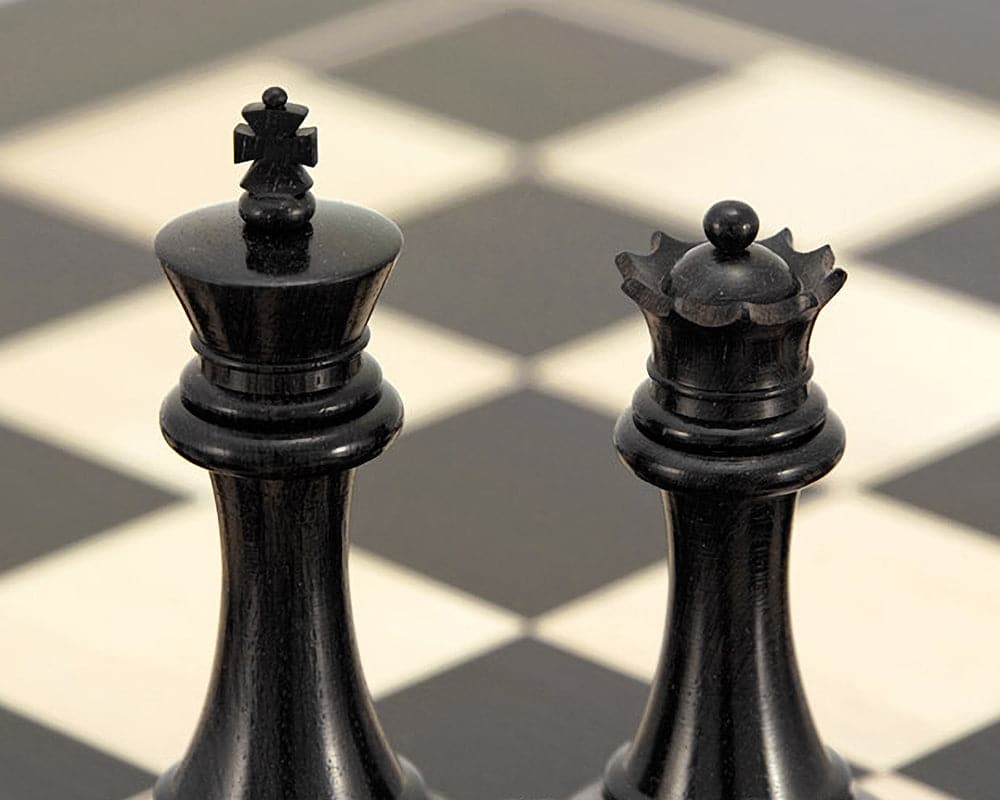 Ebony king and queen chess pieces from Sovereign Series, Staunton design, on chessboard