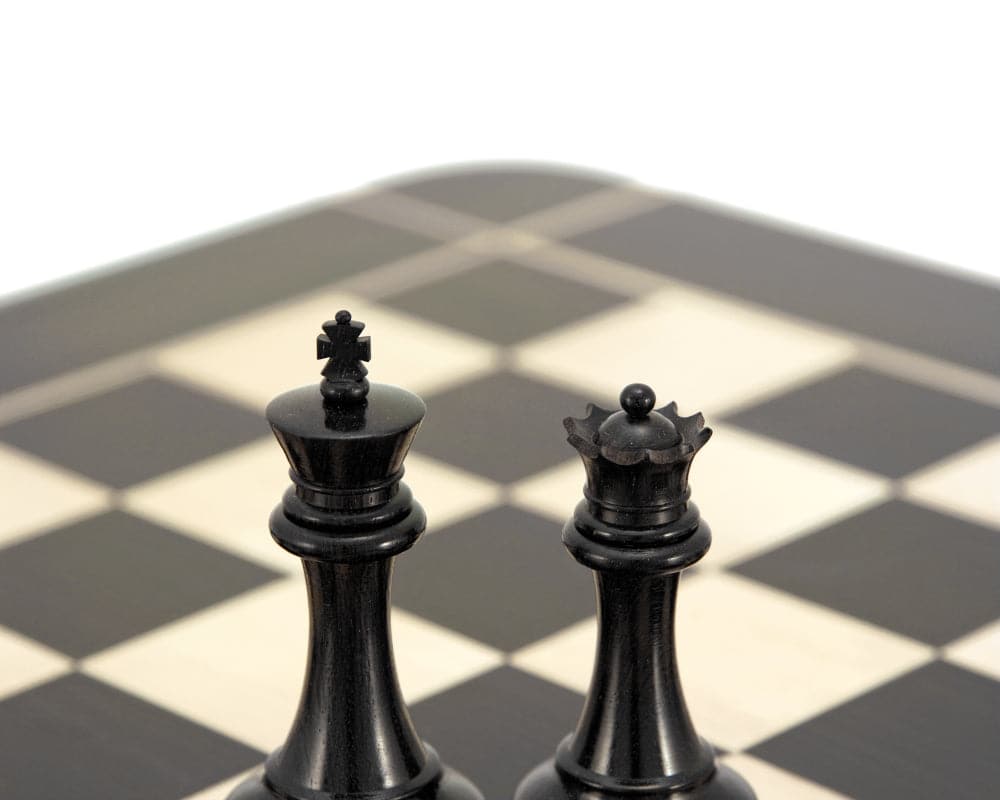 Sovereign Series Ebonised Boxwood Chessmen displaying king and queen on chessboard