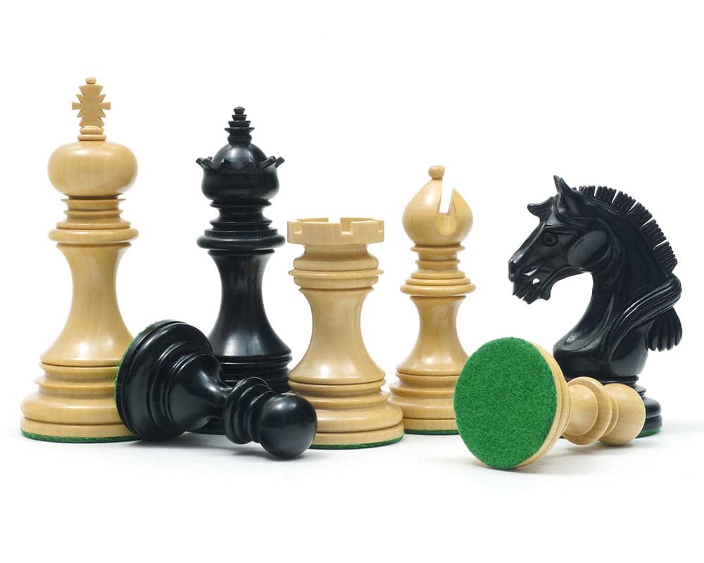 The Garvi Ebony Chessmen 4 Inches set showing expertly crafted Staunton pieces with Mughal influence, felt bases, and additional queens.