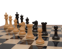 Reproduction Staunton Ebony Chessmen 1849 Model with 4.4 inch King on chessboard, featuring handcrafted ebony and boxwood pieces.