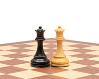 Ebonised and boxwood chess kings on chessboard in traditional Staunton design