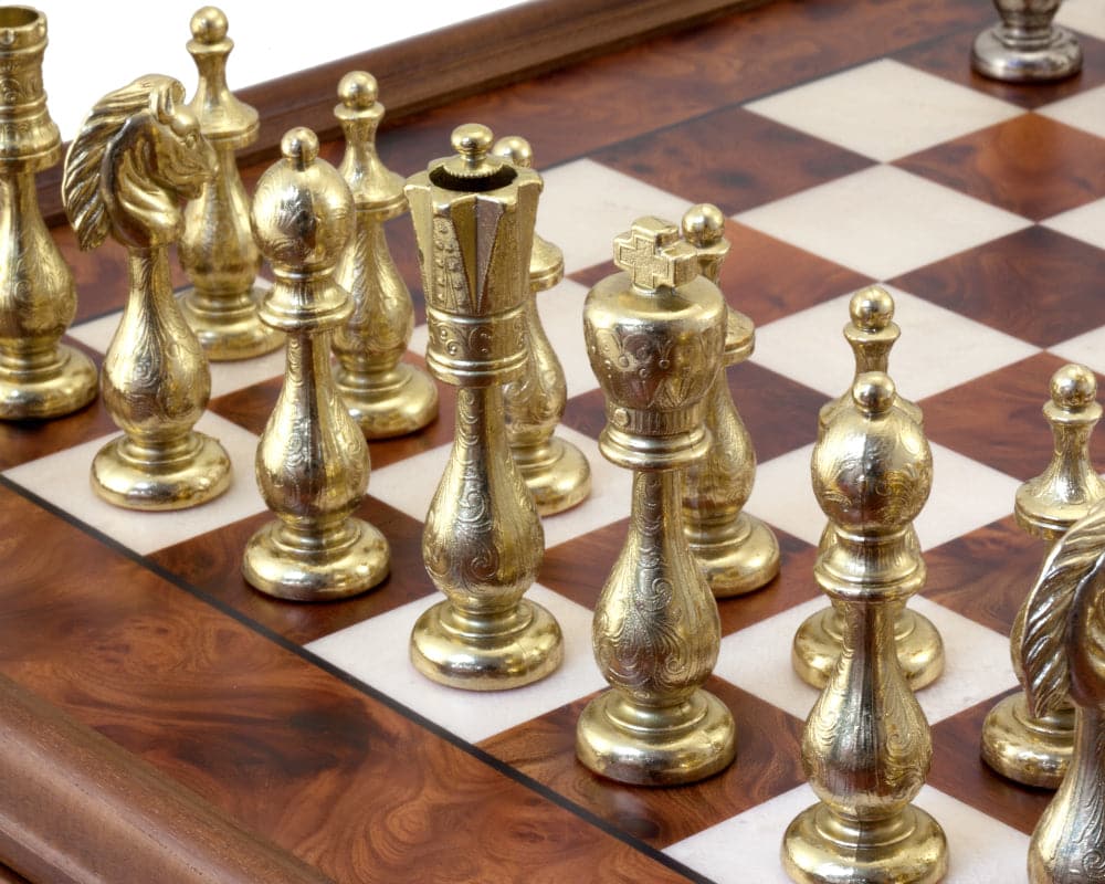 Close-up of brass chess pieces on a Briarwood and Maple chessboard from the Maghreb Chess Cabinet