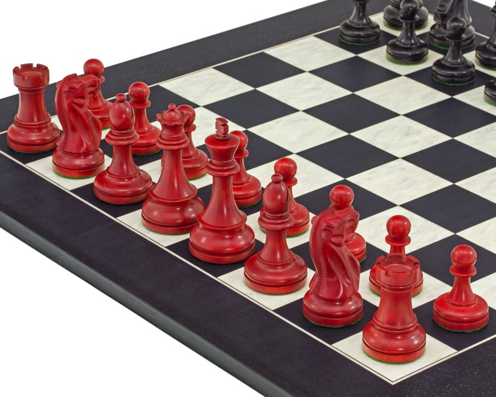 Red and black Staunton design chess set on black and maple board with 3.75 inch king, weighted pieces and billiard cloth bases.