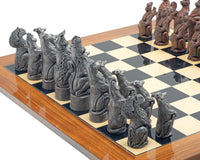 The Berkeley Chess Royal Beasts Metal and Palisander Grand Chess Set pieces on a wooden chessboard
