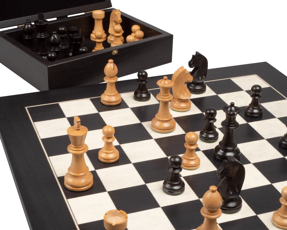 The Down Head Knight and Black Deluxe Chess Set with wooden pieces and case displayed on a chessboard.