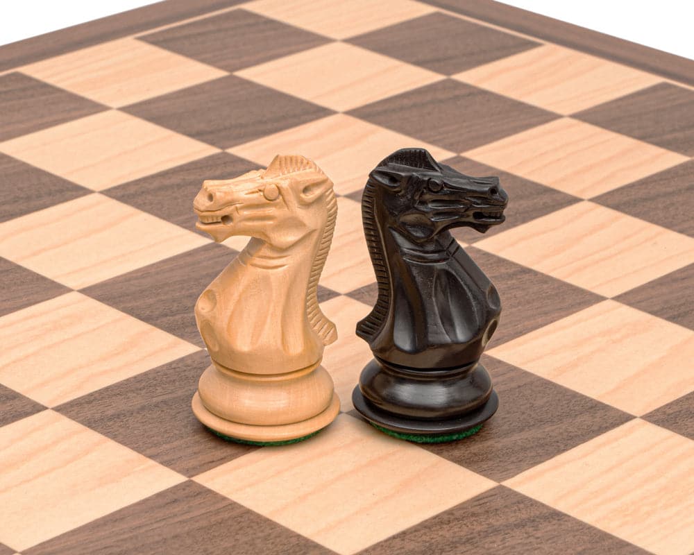 Black and maple Stallion knight chess pieces on Spanish chess board with walnut and maple veneers.