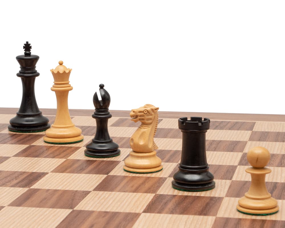 The Old English Elite Walnut and Black Deluxe Chess Set with classic Staunton design pieces on a walnut and maple veneer board.